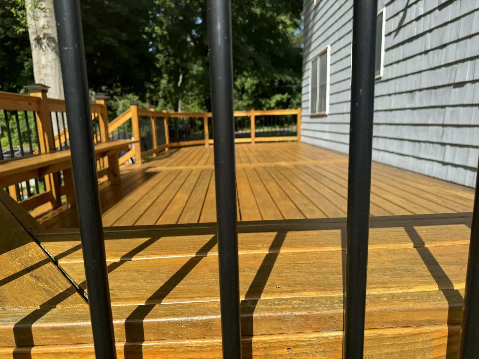 Freshly stained wood deck with a warm natural finish